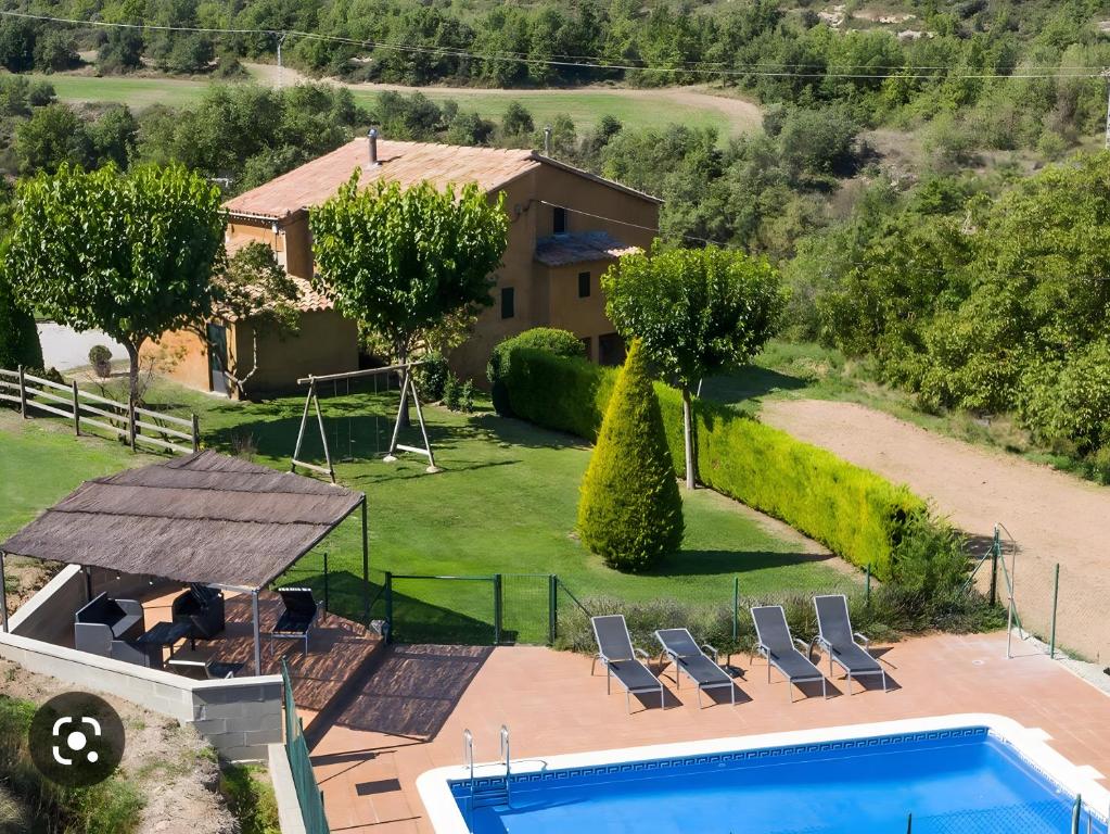 an aerial view of a house with a swimming pool at Cal Colom - Agroturisme in Puigreig