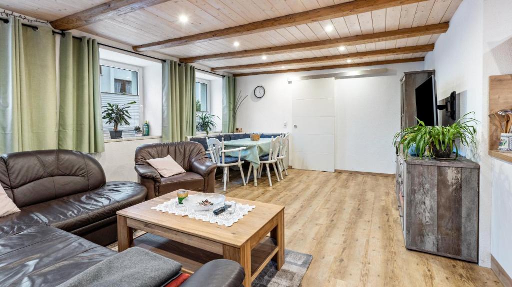 a living room with a couch and a table at Ferienwohnung Haas in Bräunlingen