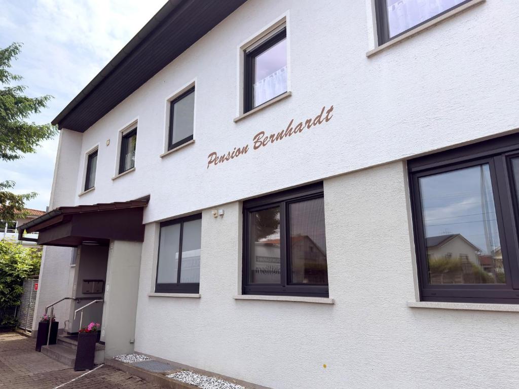 a white building with a sign on the side of it at Haus Bernhardt in Langenargen