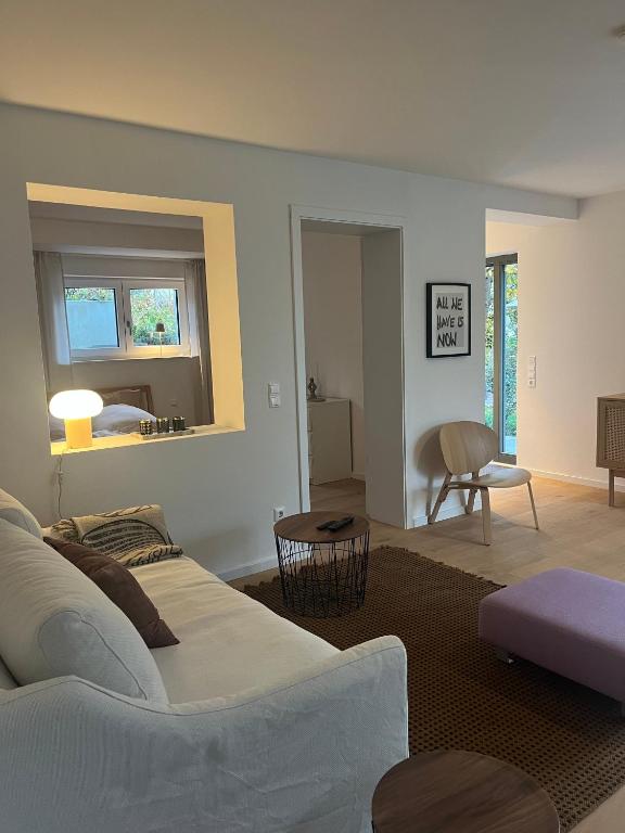 a living room with a white couch and a table at Feigental in Überlingen