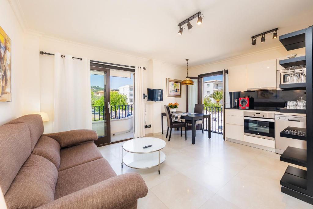 a living room with a couch and a table at Brillant in Cala Ratjada