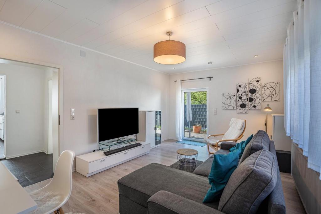 a living room with a couch and a tv at Ferienwohnung Drachenstein in Weinheim