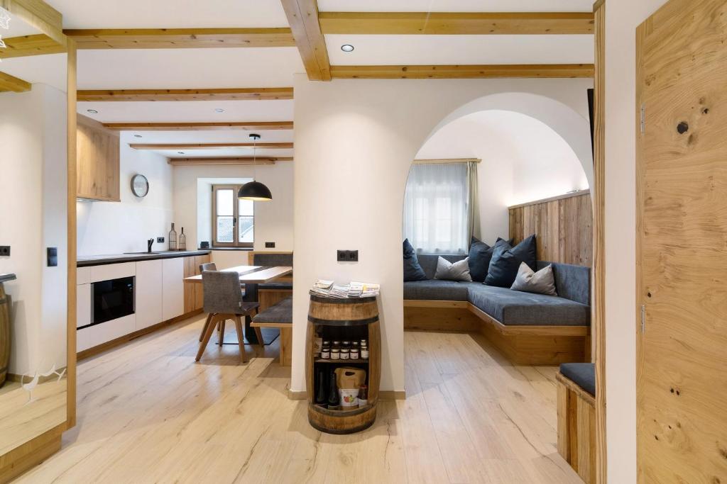 a living room with a couch and a table at Bertollhof Weingenuss in Silandro
