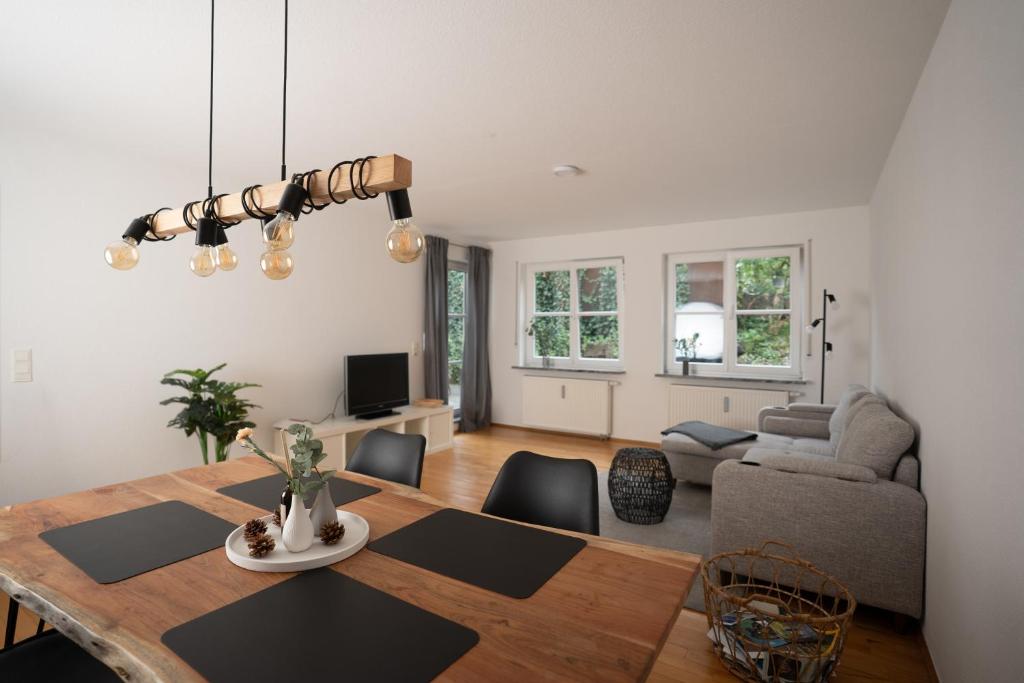 a dining room and living room with a table and chairs at Lo Ferienwohnung in Friedrichshafen
