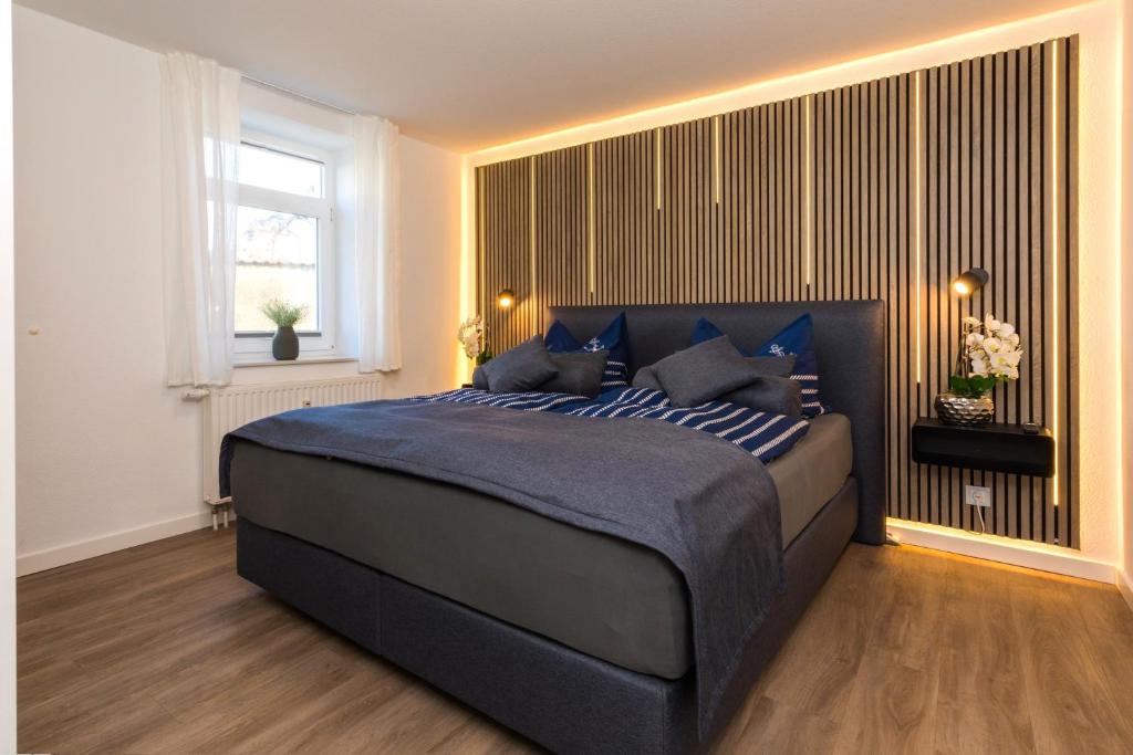 a bedroom with a large blue bed with a window at Villa Marin Wohnung 1 in Zinnowitz