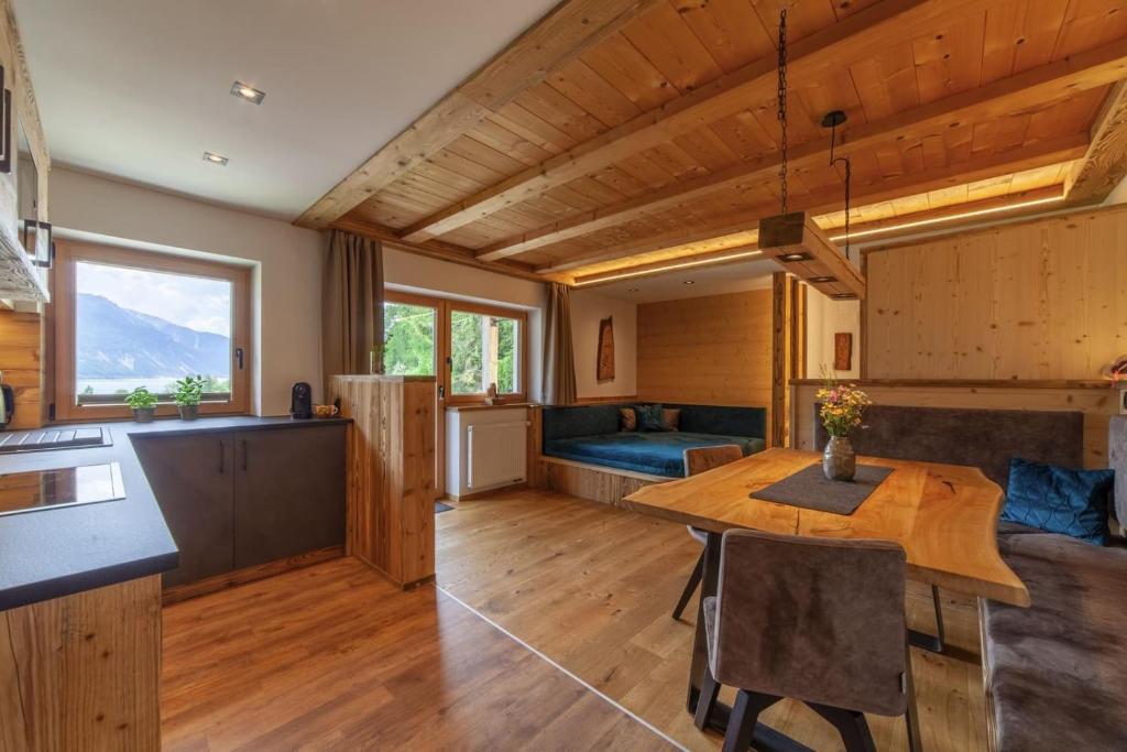 a kitchen and living room with a table and a couch at Mühlanderhof Apt Piz Lad in Resia