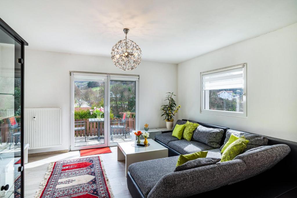 a living room with a couch and a chandelier at Vogtshaus in Gernsbach