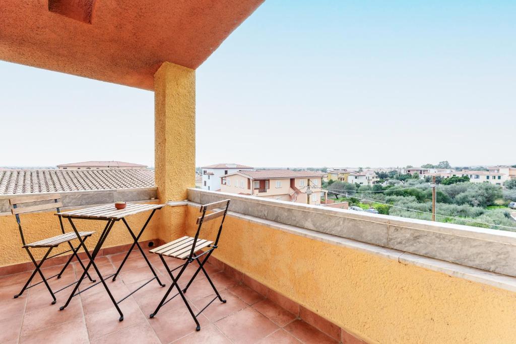 a balcony with two chairs and a table at Cozy And Cool Flat in Orosei