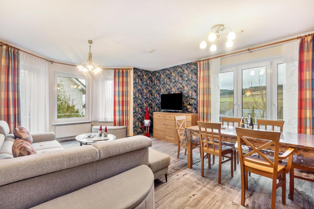 a living room with a couch and a table at Ferienwohnung Ruhrtal in Bestwig
