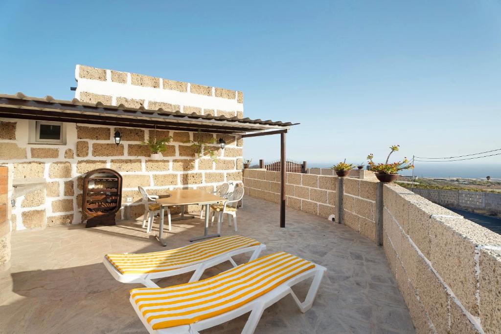 a patio with two lounge chairs and a table at Finca Eva in Granadilla de Abona