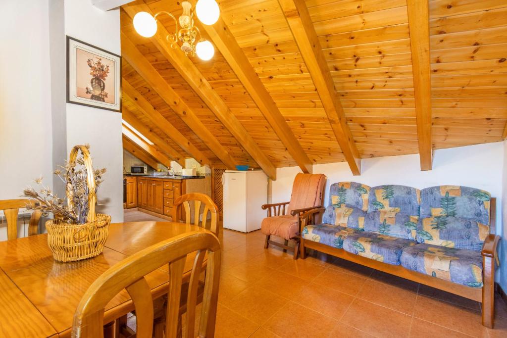 a living room with a table and a couch at La Golfa in Durro
