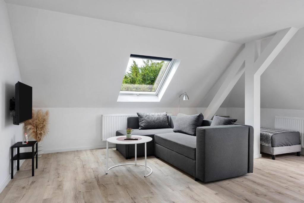 a living room with a couch and a window at Ferienwohnung 2 in Bad Salzuflen