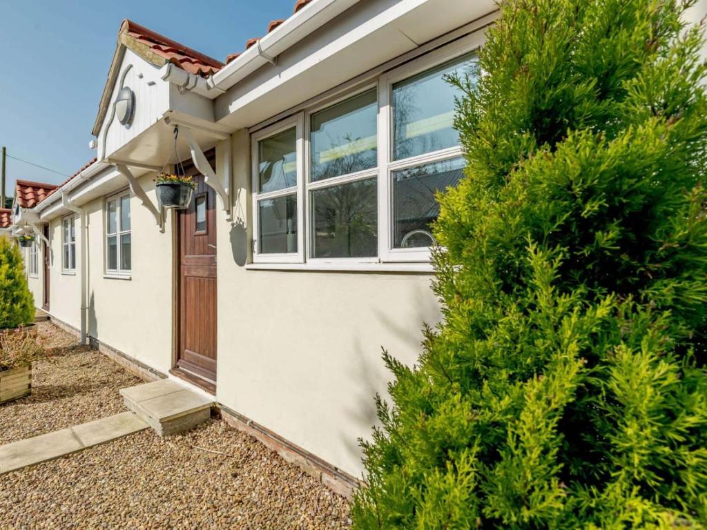a house with a tree in front of it at 2 Bed in Louth oc-53508 in Fotherby