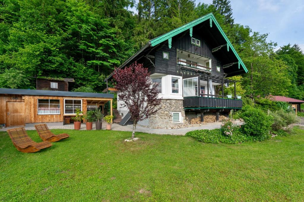 a large house with a green roof and a yard at Haus Ruheplatzerl in Ruhpolding