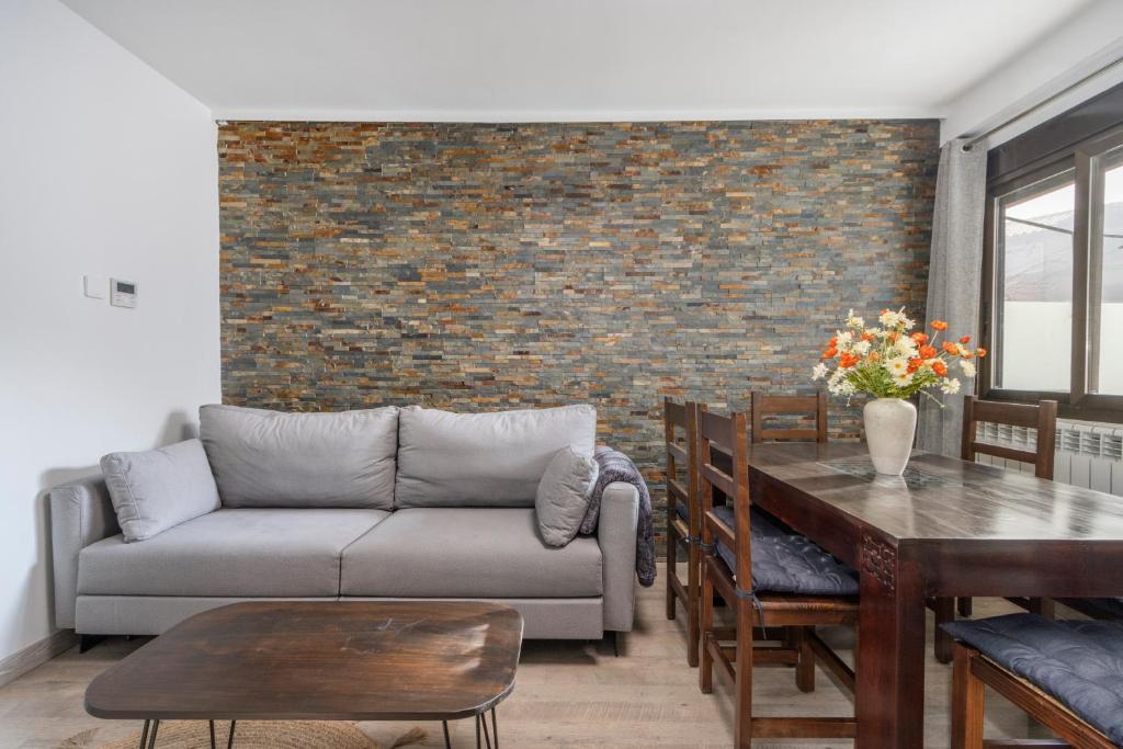 a living room with a couch and a table at El Cierzo de Sediles in Sediles