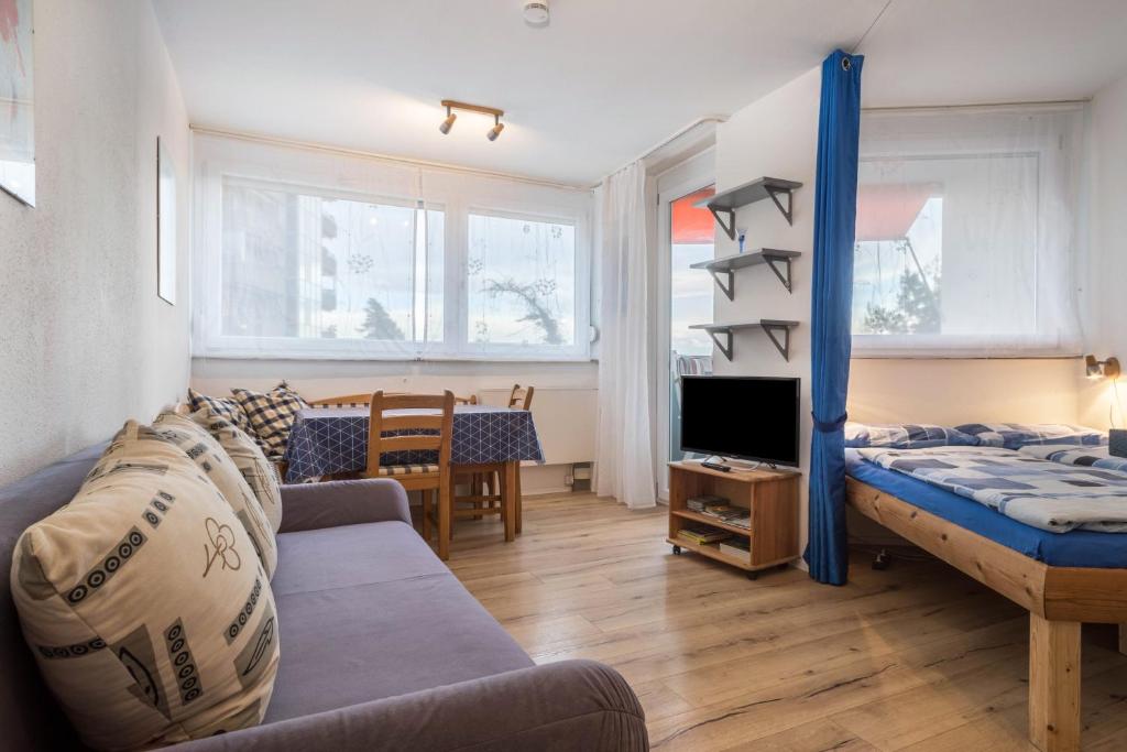 a living room with a couch and a tv at Ferienwohnung Förster in Überlingen