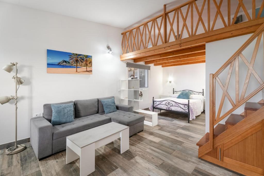 a living room with a couch and a bed at Loft de Tato in Frontera