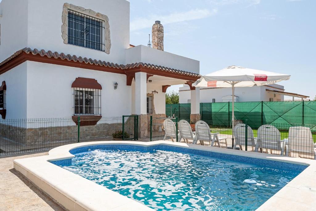 a swimming pool in front of a house at Las Alas del Sol in Vejer de la Frontera