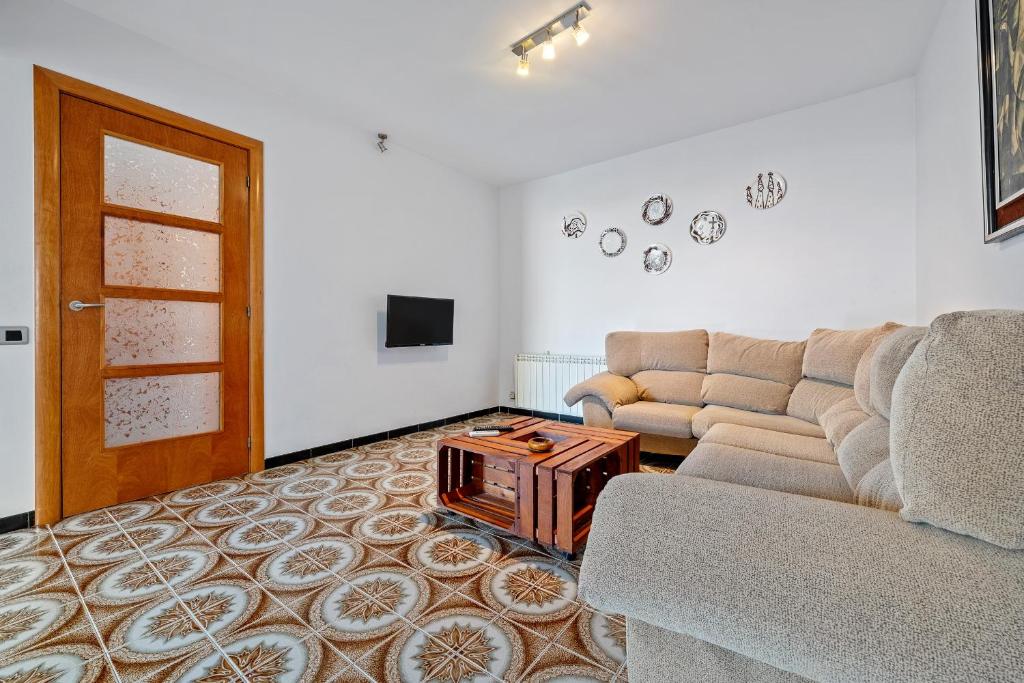 a living room with a couch and a table at La Garrofera in Aldover