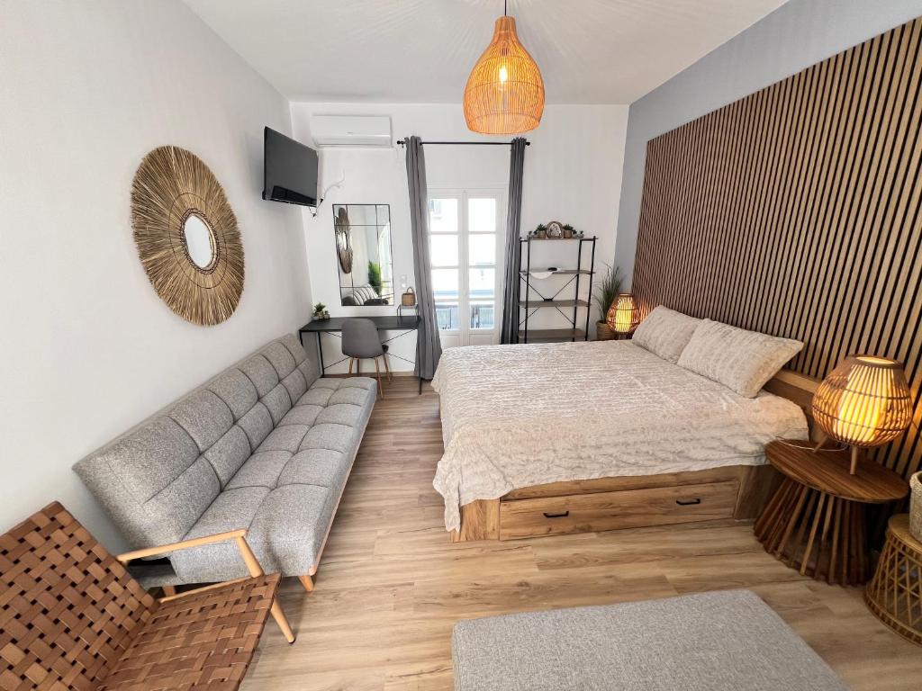 a living room with a bed and a couch at aeolian blu 4 in Parikia
