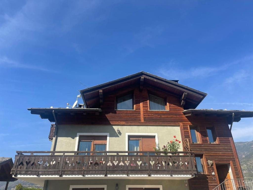 a wooden house with a balcony on top of it at Au Petit Chevrot - Classic in Aosta