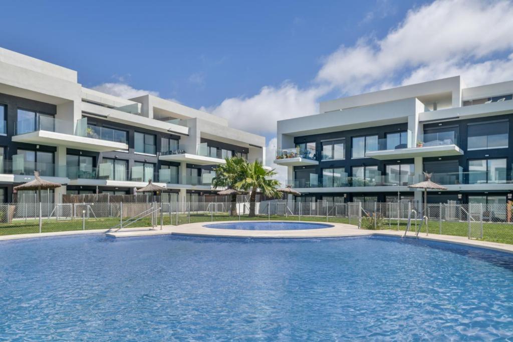 a building with a swimming pool in front of a building at Casa África in Zahara de los Atunes