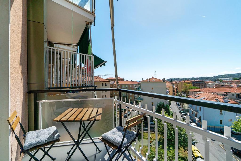 a balcony with two chairs and a table on a balcony at Casa A Prima Vista Varazze in Varazze