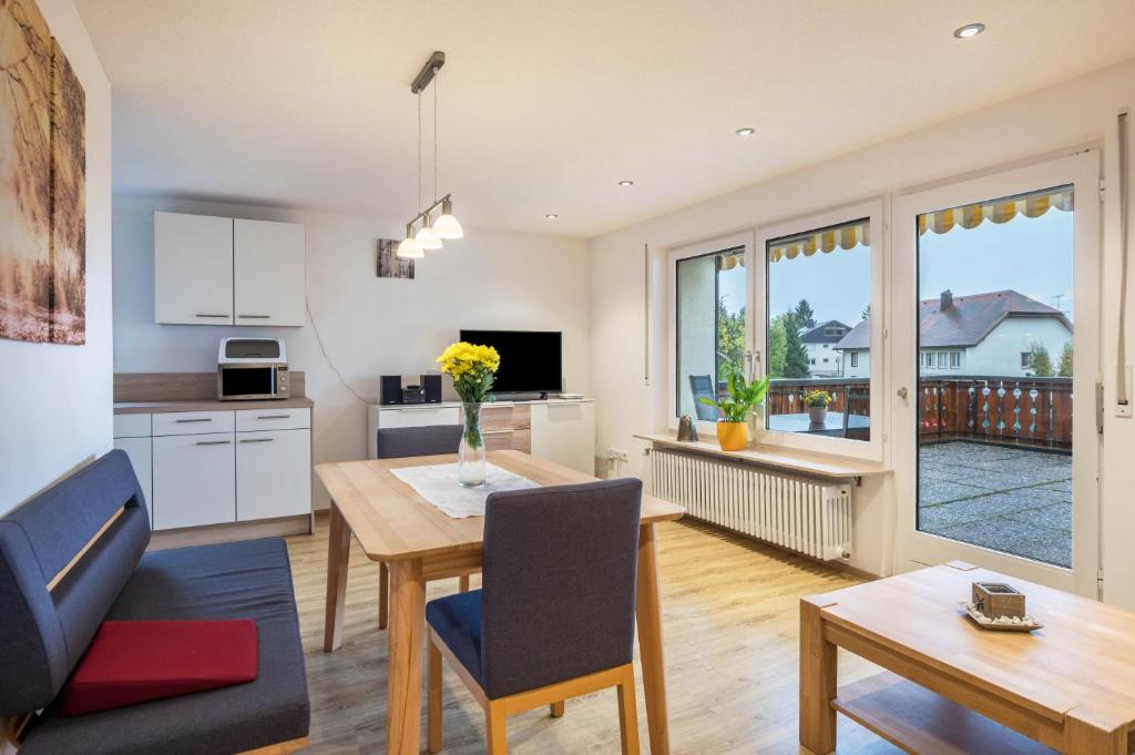 a kitchen and living room with a table and a dining room at Ferienwohnung Nr 5 Sonnenschein in Höchenschwand