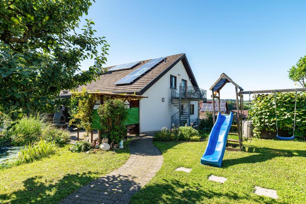 a house with a slide in the yard at Hügelblick Oase in Kraichtal