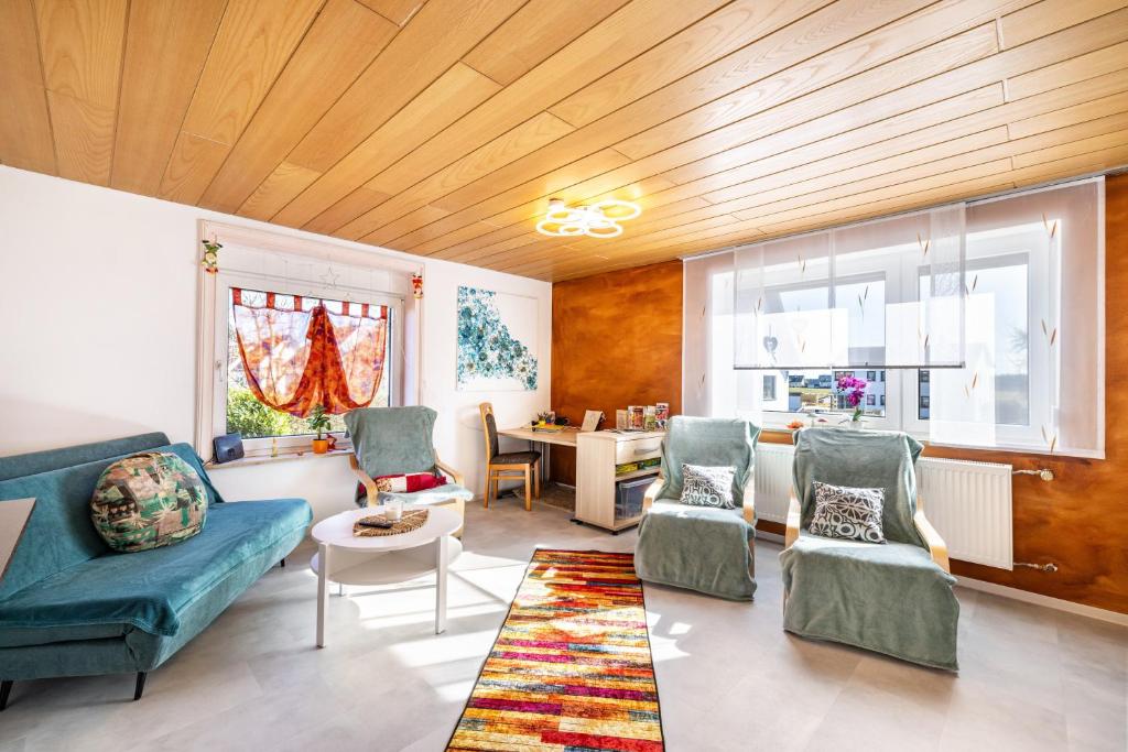 a living room with a couch and chairs and a table at Hund und Kind Appartment in Oberndorf am Neckar