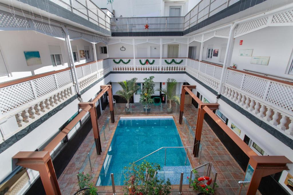an indoor pool in the middle of a building at Casa Paula - 13 in Arinaga