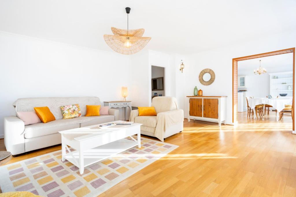 a living room with a couch and a table at Ty Corniche - 50m de la plage in Bénodet