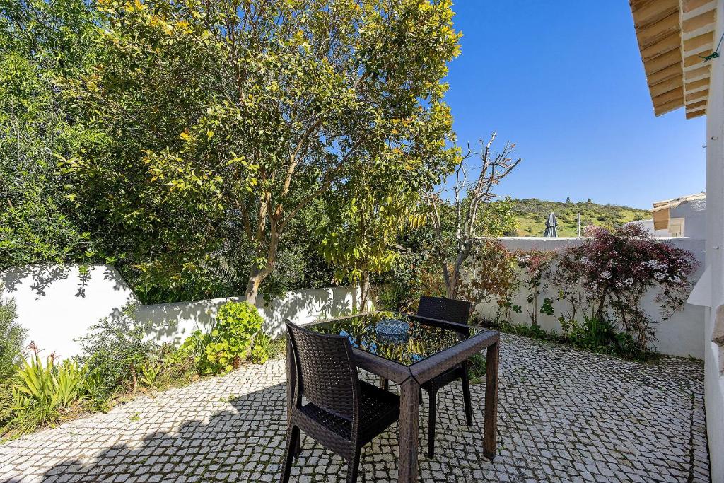 a table and chair on a patio with a laptop on it at Casa 54 in Valverde