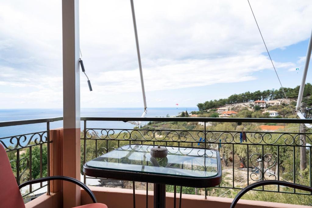 a balcony with a table and a view of the ocean at Nontas Homes 32 in Kalamitsi