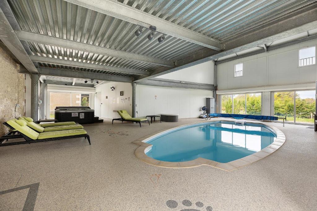 a large room with a swimming pool in the middle of it at L'aérostier Gîte - 5 Pers in Saint-Georges-sur-Cher