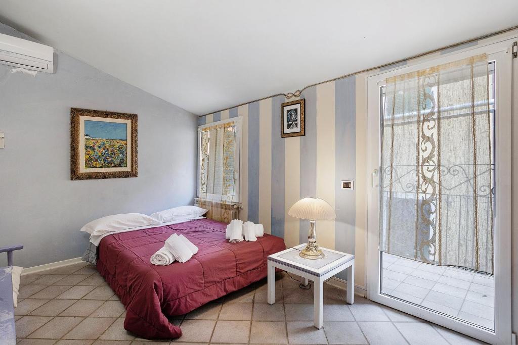 a bedroom with a bed and a table and a window at 5 Terre - Lerici - Piccolo Golfo in Lerici