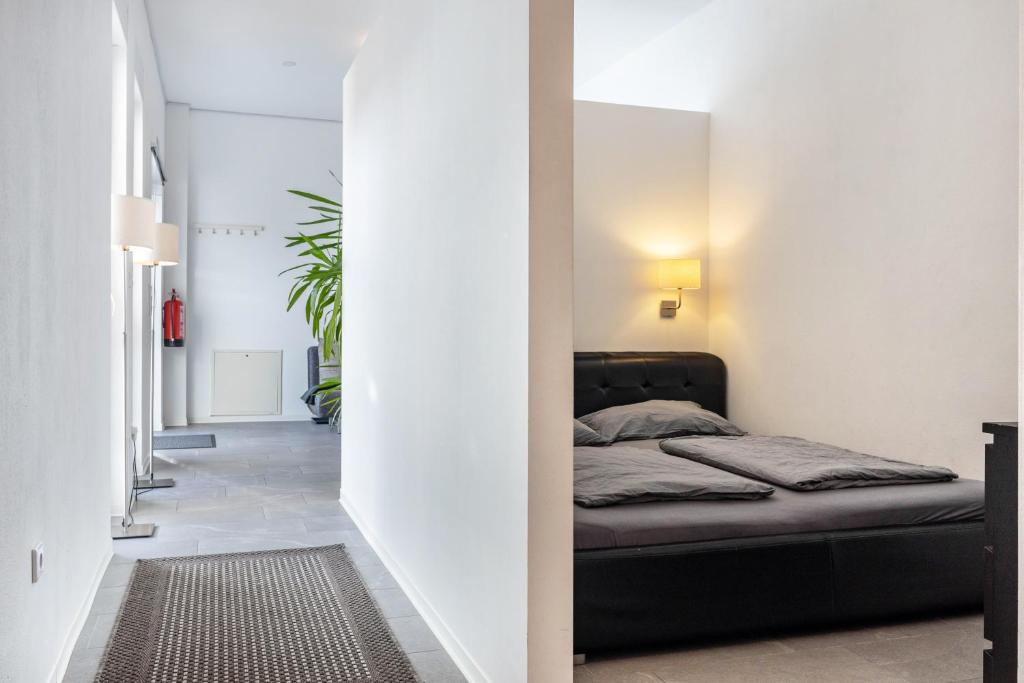 a bedroom with a black bed in a white room at Altenbeken- Ferienwohnung 1 in Altenbeken