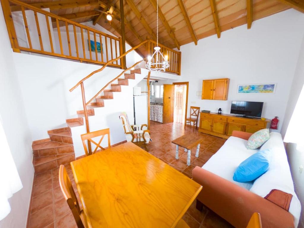 a living room with a couch and a table at Casas Pepe 5 Bungalow in Los Caños de Meca