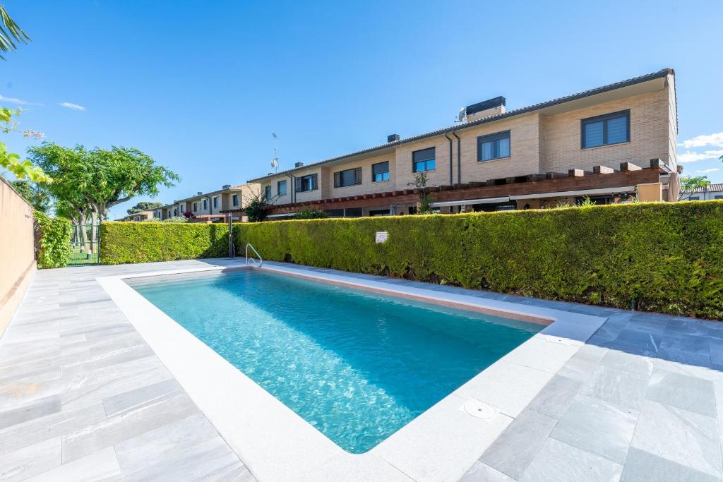 a swimming pool in the backyard of a house at Casa Emi in Cambrils