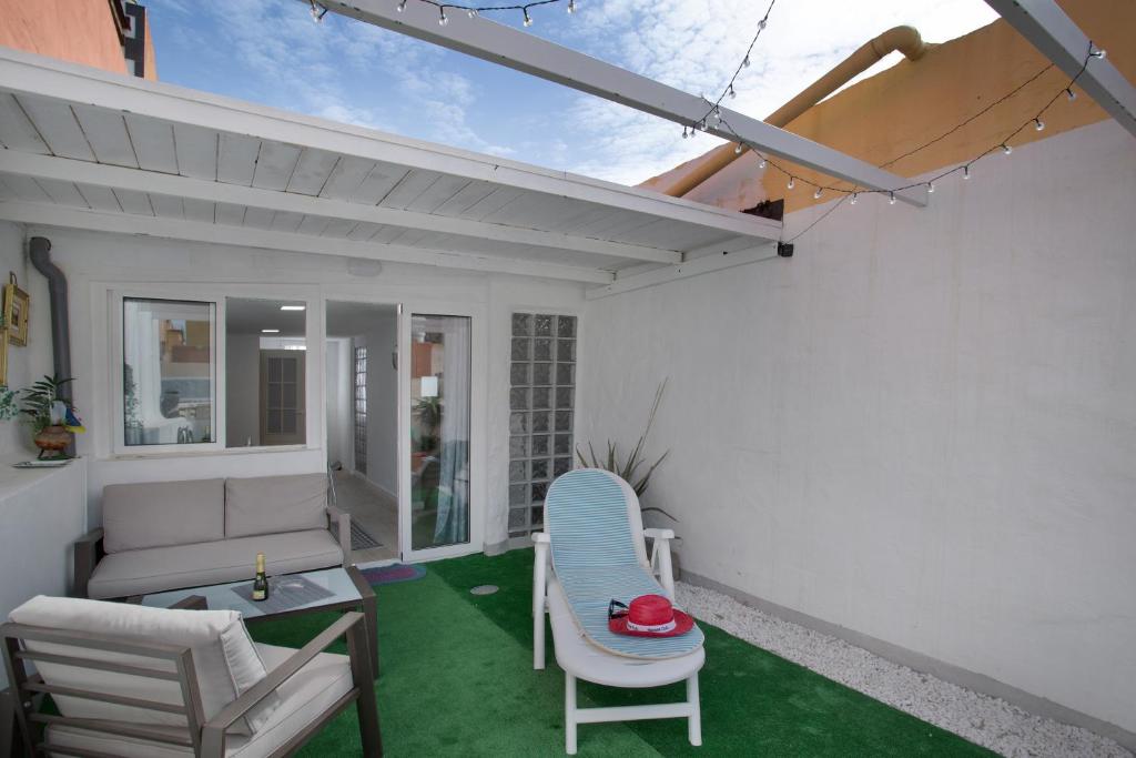 a patio with a couch and a table and chairs at Villa Monica B in Agüimes