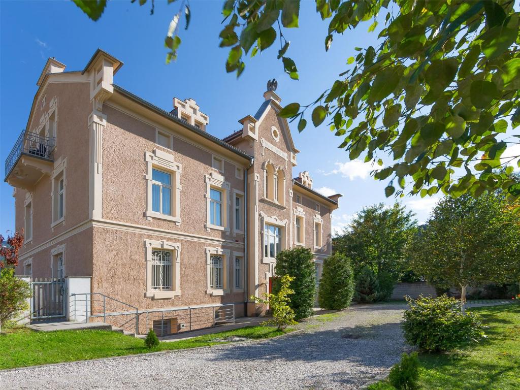 a large brick building with a yard at Villa Residence Santer in Brunico