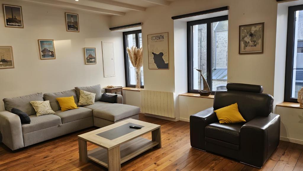 a living room with a couch and a table at gite in Saint-Vaast-la-Hougue