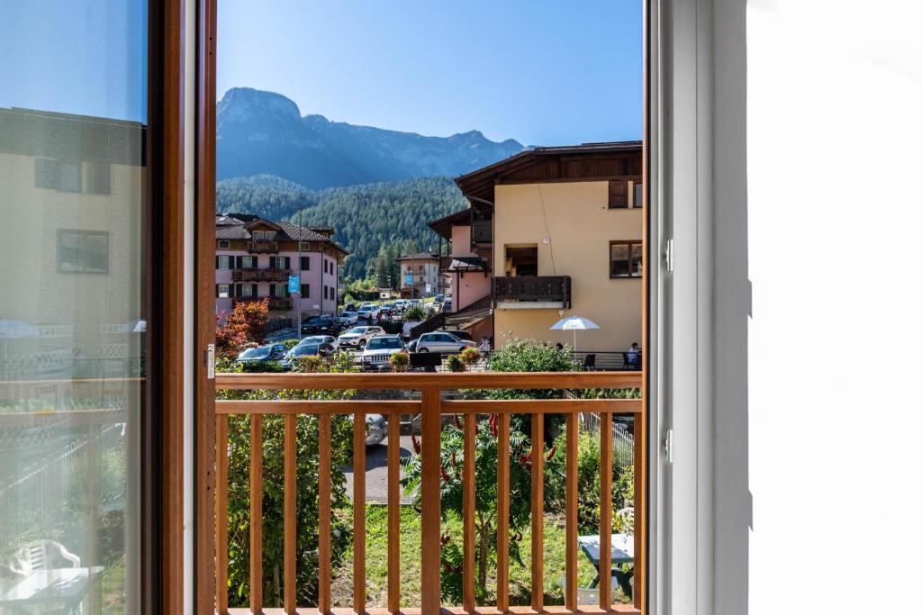 a balcony with a view of a city at Appartamento Al Sasso Rosso Dimaro in Dimaro