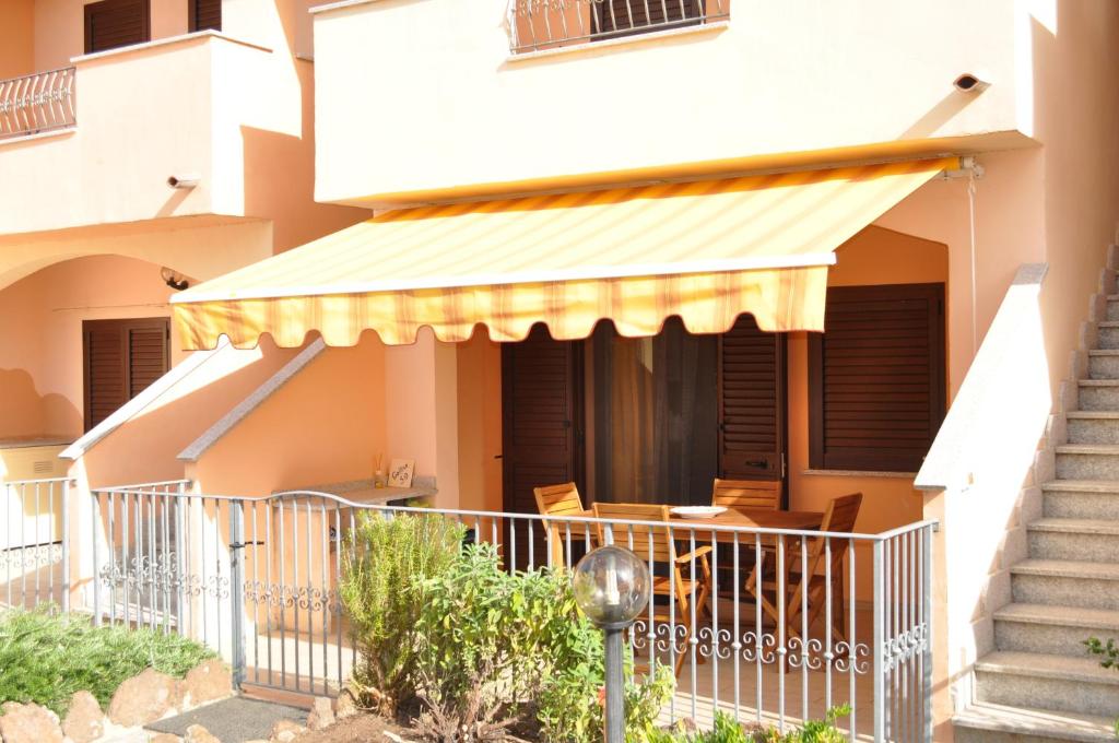a house with awning on the front of it at Casa vacanza La Rosa dei Venti in Viddalba