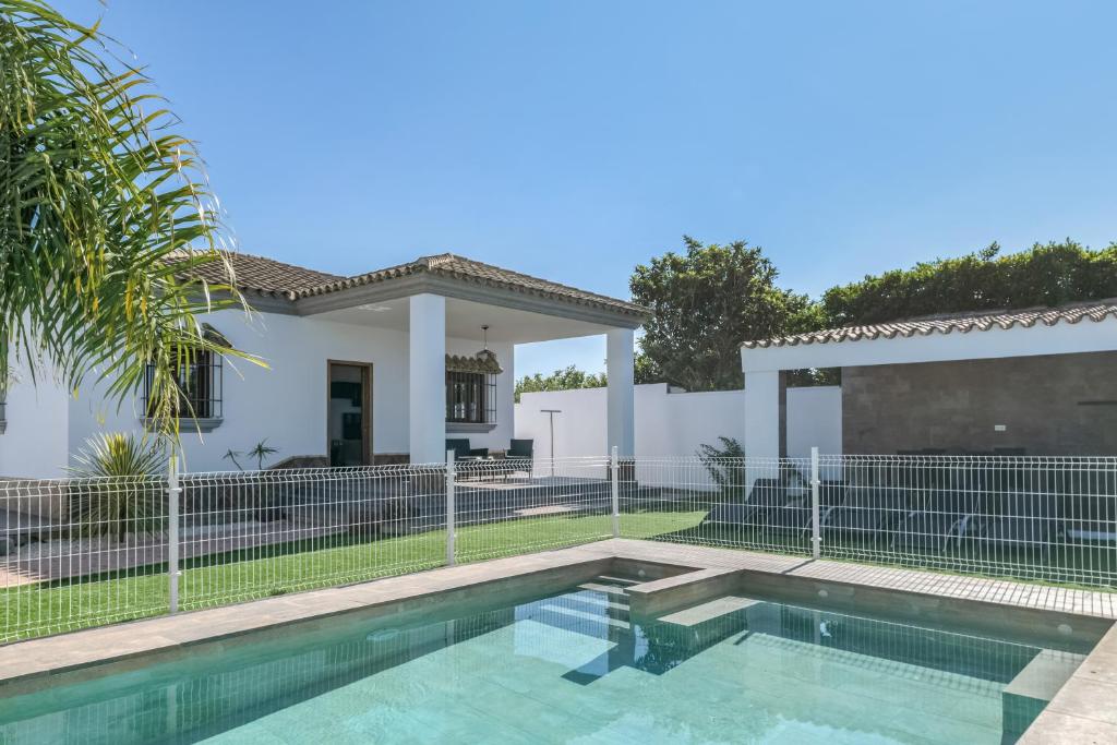 a house with a swimming pool in front of a fence at Casa Romero in Campano
