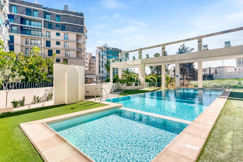 an apartment with a swimming pool in a building at Calpe Beach in Calpe
