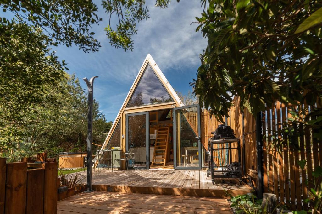a small house with a triangular roof at Tipi Lodge Glamp Marguerite in Le Boulou
