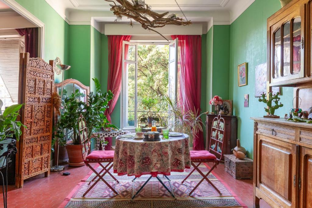 a dining room with a table and a window at Chambres D'hôtes Chez Marie in Marseille