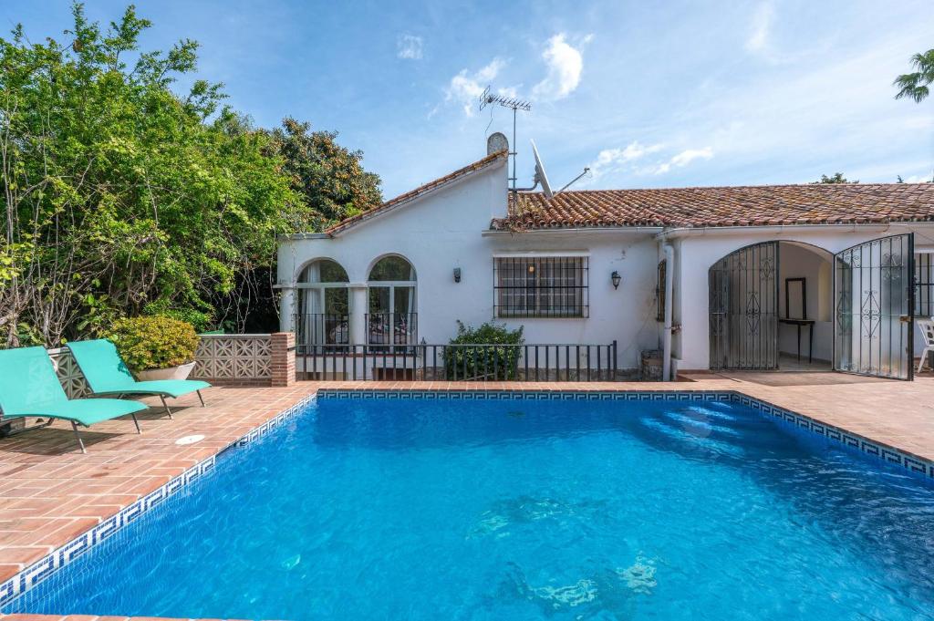a swimming pool in front of a house at Villa Marbella -pool - Beach At 300 in Marbella