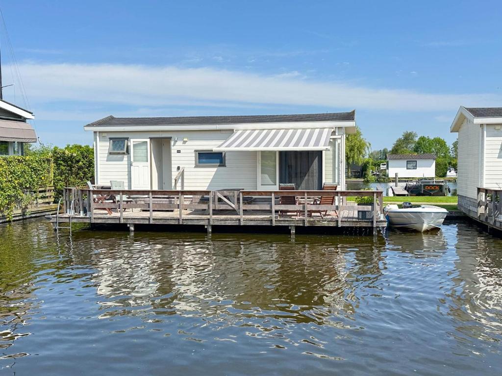 a house on a dock on a body of water at Blauwborst 24-18 in Breukelen
